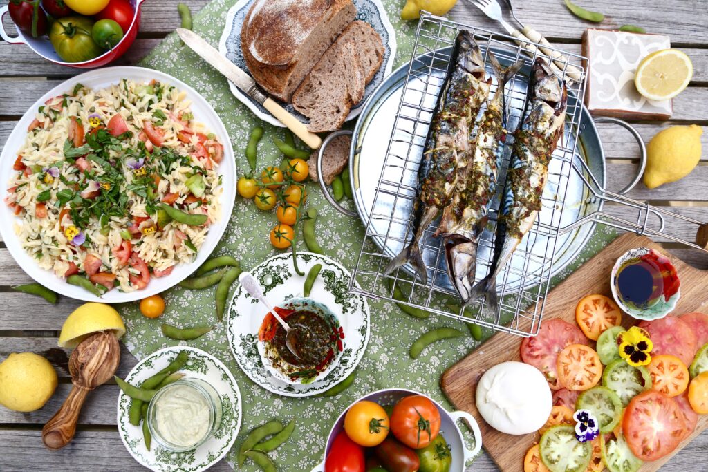 Barbecued mackerel with chillipesto drizzle, and heirloom tomato orzo